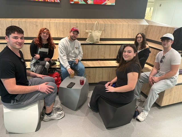 JHP Temple students sitting together with coffee at the business school coffee shop
